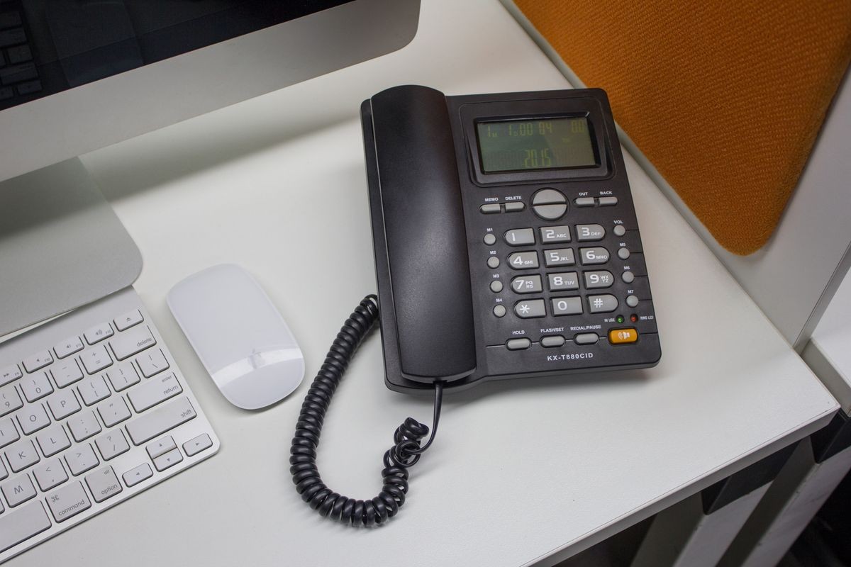 Black telephone on white office desk